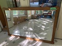 Mirror showing full frame and reflection of room