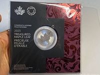 Front view of the original packaging showing the silver maple leaf coin and decorative folder with certificate text.