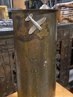 Front view of the artillery shell with airplane decoration attached near top