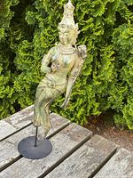 Full front view of bronze deity on stand