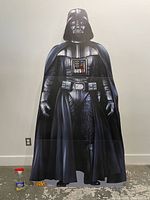 Full view of the 75-inch tall cardboard Darth Vader standee showing detailed costume graphics and painted features including helmet, cape, chest panel, and boots.