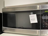 Closed view of Frigidaire stainless steel microwave on countertop