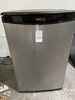 Front view of the Danby mini fridge showing the stainless steel door and black top trim with brand logo.