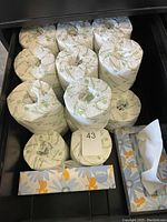 25 individually wrapped toilet paper rolls and 1 Kleenex tissue box visible.