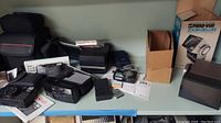 Overhead view of all cameras, slide projector box and bag on table