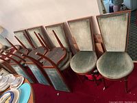 Eight chairs arranged with some stacked, showing overall set