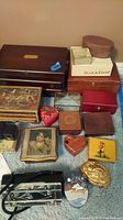 Wide view of assortment of mixed material jewelry and trinket boxes including large wooden box and various smaller decorative boxes