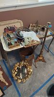 Overview photo showing various metal ware items including candle holder, umbrella bucket, snack trays, metal bowls, trays and decorative metal pieces.