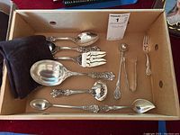 Overview of all ten sterling silver serving utensils in box