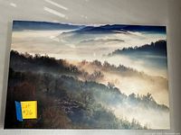 Frontal view of the foggy mountain landscape wall art showing the full image with mist and trees.