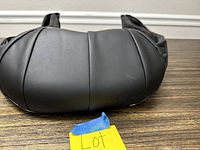 Bottom view showing the padded black synthetic leather surface of the electric massager