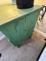 Side view of pine wood nightstand showing green wash finish and wood grain detail