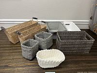 Overview photo showing all eight baskets of varying sizes and colors on the floor.