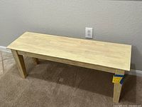 Front angle view of the parawood Shaker style dining bench showing butcher block surface and tapered legs.