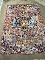Full view of the vintage Bohemian-style area rug showing the colorful central medallion and intricate pattern.