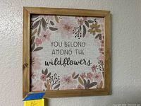 Front view of framed wall art with floral design and text 'You belong among the wildflowers'