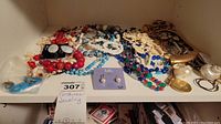 Assorted necklaces and earrings spread on shelf