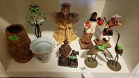 Front view of all figurines and vases on display shelf