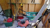 Overall view showing mower, wagon, ladder and leaning shovels