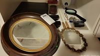Large oval mirror with dark wood and gold frame