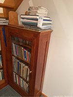 Taller wooden bookshelf filled with vintage and newer children's books including Little Golden Books. Spines show various colorful titles; some classics and vintage titles are visible.