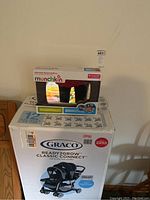 Graco Ready2Grow Classic Connect stroller box with Munchkin adjustable backseat mirror box on top