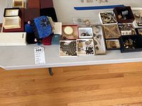 Overview of assorted jewelry pieces and empty jewelry boxes on table