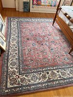Full view of rug laid on hardwood floor below bed frame