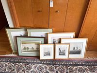 Group shot of all seven framed prints arranged on floor