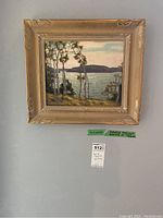 Full-frontal view of the framed painting against a gray wall with lot tag below