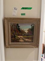 Full view of framed painting hanging on wall with labels visible