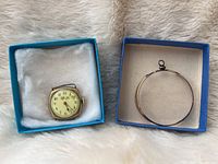 Photo of both the watch case and magnifying loop in separate blue boxes, showing the condition and packaging.