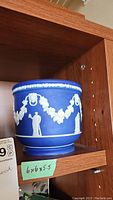 Side view of cobalt blue Wedgwood jasperware jardiniere on wooden shelf with size note 6x6x5.5 inches