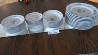 Full set of stacked plates and bowls arranged on table showing quantities