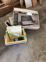 Original boxed Coleman two burner propane stove with mini propane canister inside Thermos cooler box