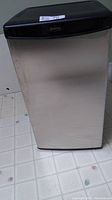 Closed view of Danby bar fridge showing stainless steel exterior and black top panel