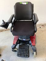 Front view of wheelchair showing seat, backrest, joystick on right armrest