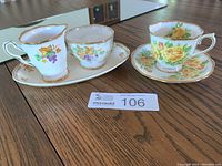 Photo showing Royal Stafford creamer and sugar bowl on tray alongside Royal Albert Tea Rose teacup and saucer on table.