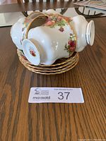 Four Royal Albert Old Country Rose teacups stacked on matching saucers, showing gold trim and floral pattern.