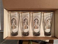 Set of four Coors Beer glasses in original cardboard box with visible mountain logo and gold rim needing cleaning