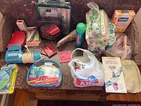 Wide view of the lot showing various toiletries, bath beads, razors, lip balms, travel kits, and grooming accessories.