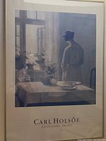 Framed poster showing Carl Holsøe artwork 'Connaught Brown', a woman standing by a window in an interior setting