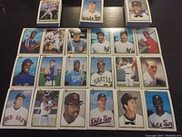 Top-down view showing arranged 1990s MLB baseball cards featuring various players in uniforms from multiple teams such as White Sox and Cubs.
