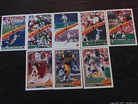Photo showing nine NFL football cards from the Ariel Threats series laid out, featuring players in various team uniforms and poses with prominent orange and black diagonal logo.