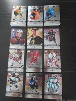 Clear photo of twelve individual Black Diamond NHL hockey cards arranged in a 4x3 grid showing player images and logos.