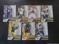 Eight NFL football cards showing players from different teams including Buffalo Bills, Tampa Bay Buccaneers, Cleveland Browns, Philadelphia Eagles, Green Bay Packers, Pittsburgh Steelers, Dallas Cowboys, and New York Giants.