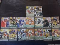 Photo showing 14 NFL Ultra Draft Pick football cards in near mint condition, featuring various players.