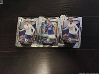 Photo showing three Panini Prizm Premier League soccer cards featuring players in team kits; Tottenham Hotspur and Leicester City visible