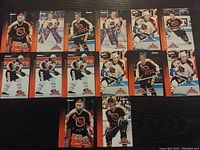 Fifteen Pinnacle NHL hockey cards laid out on black surface showing players in uniform, including goalies and skaters from various teams, with clear Pinnacle branding and designs