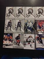Photo showing 12 SP Authentic NHL hockey cards laid out in three rows, featuring players in various team uniforms and poses on glossy card stock.